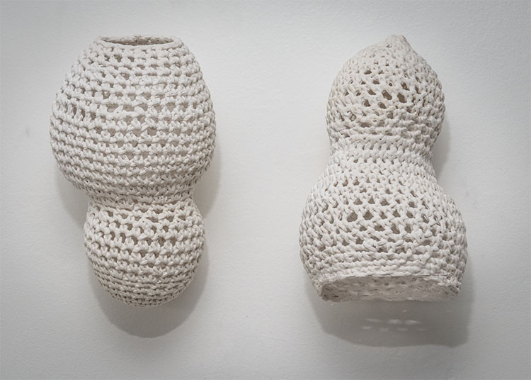 two pear-shaped white cotton yarn objects that were crochet to resemble polarizing body shapes
