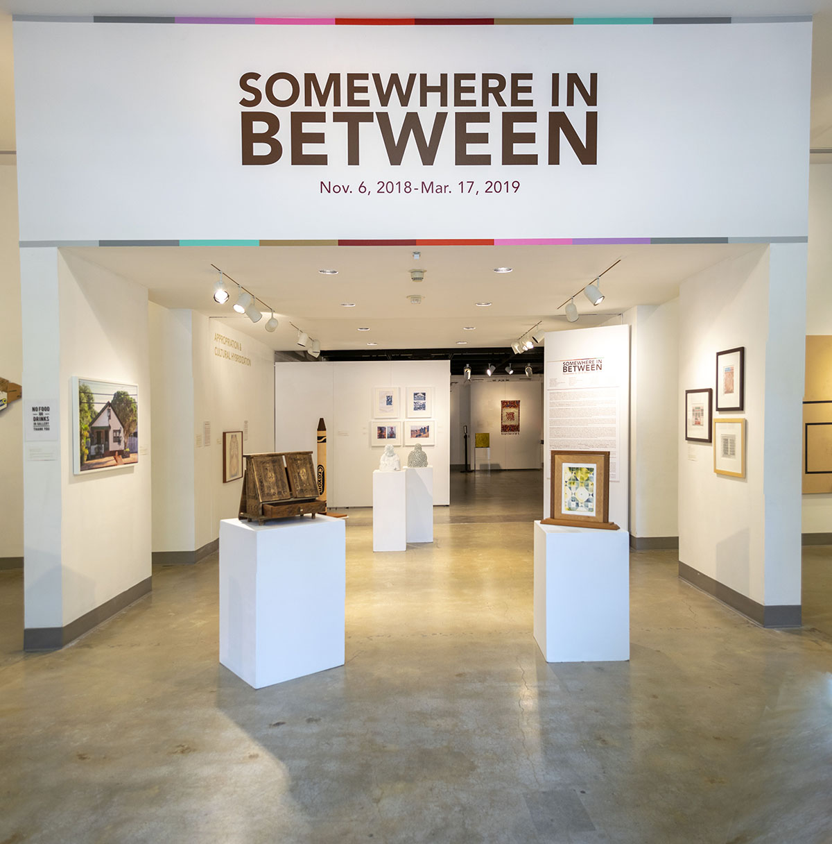Title Wall entrance view of the gallery, Exhibition: Somewhere In Between, Nov 6, 2018 - Mar 17, 2019, Co-curated by Michele Cairella Fillmore & Bia Gayotto, W. Keith & Janet Kellogg Art Gallery, Cal Poly Pomona.