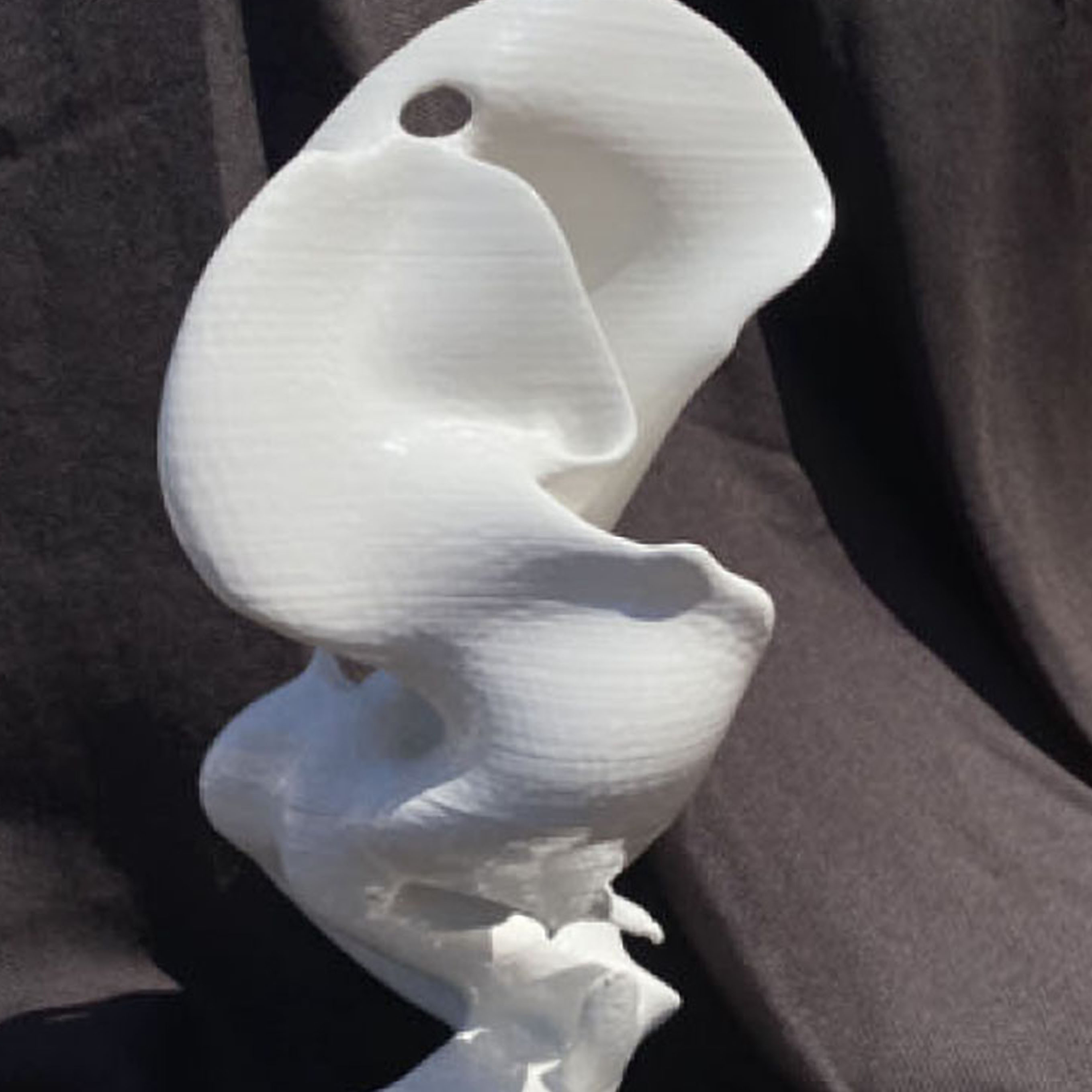 white abstract sculpture that is twisted