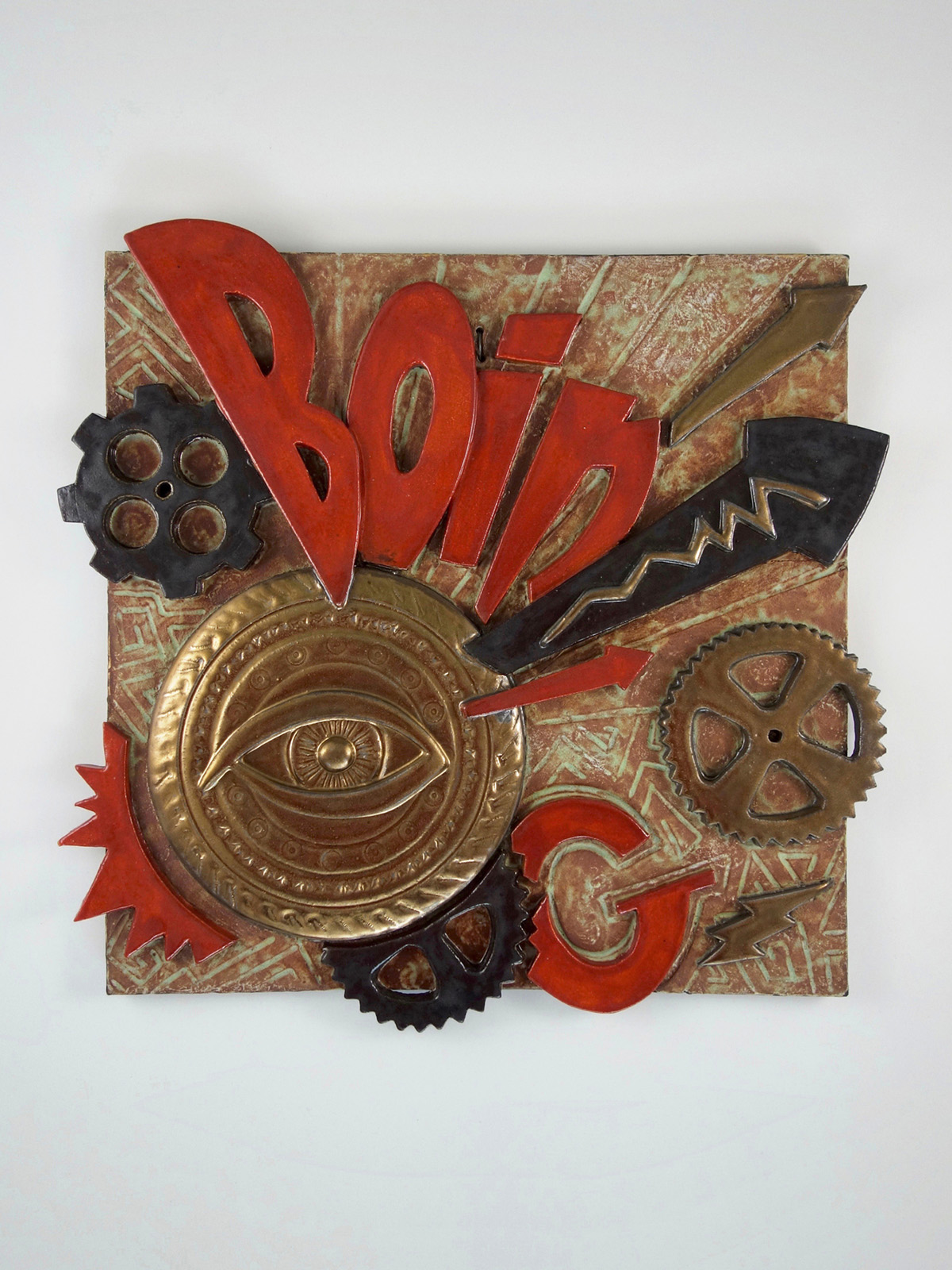  a wall plaque with the word "BOING" in red lettering with metal and black colored cog wheels with arrows pointing off the side of the gold eye under the word.