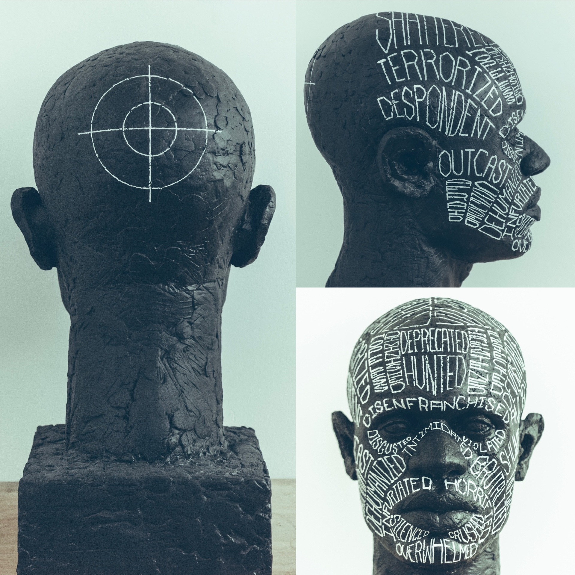 a bust of a man with white ink that was hand-lettered on the face and the back of the head there is a target.