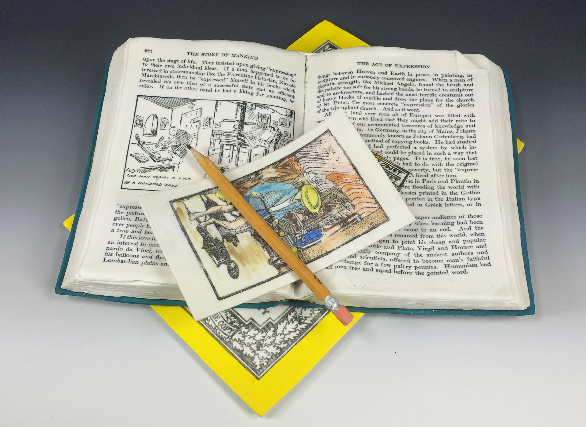 An open book sitting on a magazine or book with a bright yellow border. A postcard and pencil sit on top of the book. This is all made of clay.