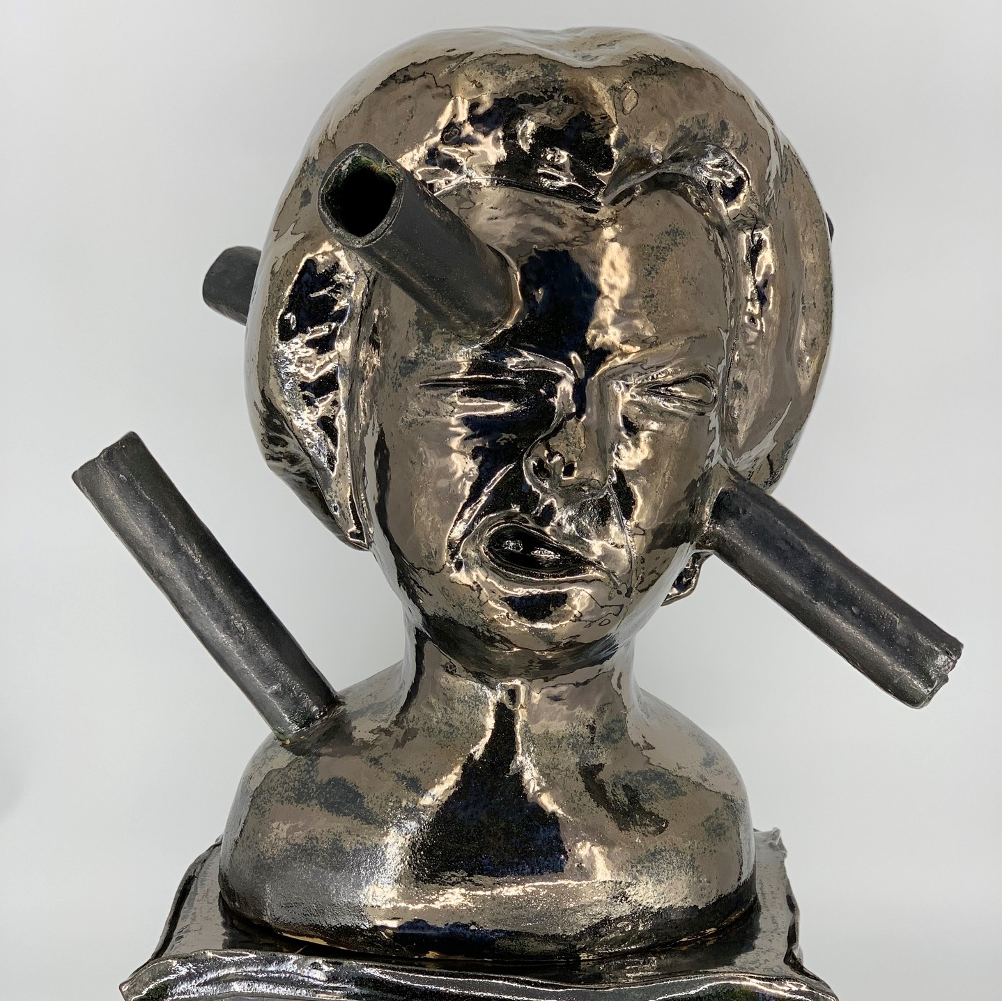 a bust of a young person with bars going through the face, head, and shoulder with a pained expression and the caption of the bust says, "Year of 2020".
