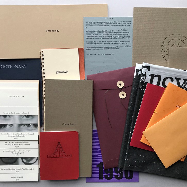 multiple different types of books spread out and/or put into specially labeled gray folders.