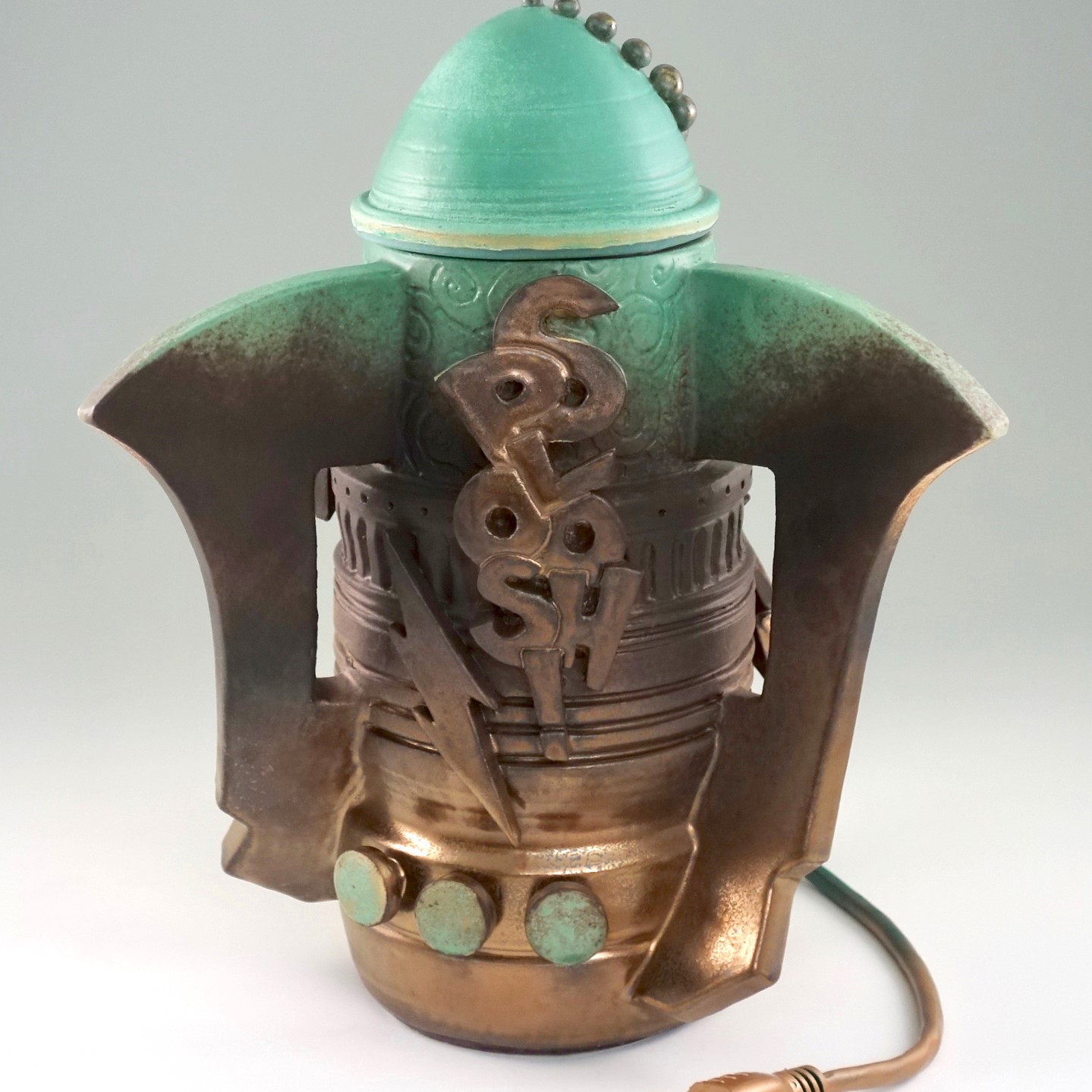 retro futuristic style bronze and mint colored jar that has a wall plug and the word "SPLOOSH" on the front with three mint colored buttons and a lightening strike.