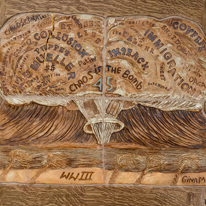  a wooden frame that showcases a mushroom cloud that contains different words with the numbers "45" in the middle of the cloud with the letters "WWII" beneath the mushroom cloud.