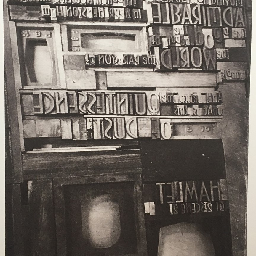 black and white print of varoius blocks with letter on them. It seems that the letters and words are backwards.