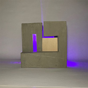 front view of square sculpture made out of concrete casting, wire, wire mesh, basswood, LED lights