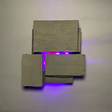 top plan view of square sculpture made out of concrete casting, wire, wire mesh, basswood, LED lights