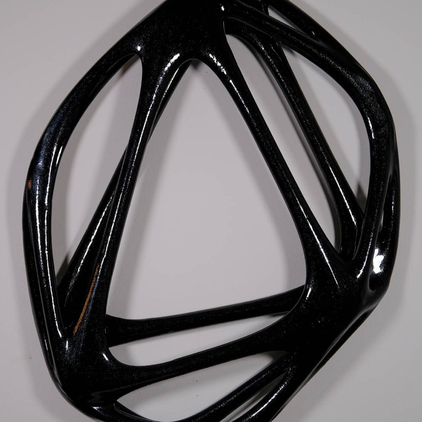Absicca: Image description: statue of a black, circular, geometric artwork