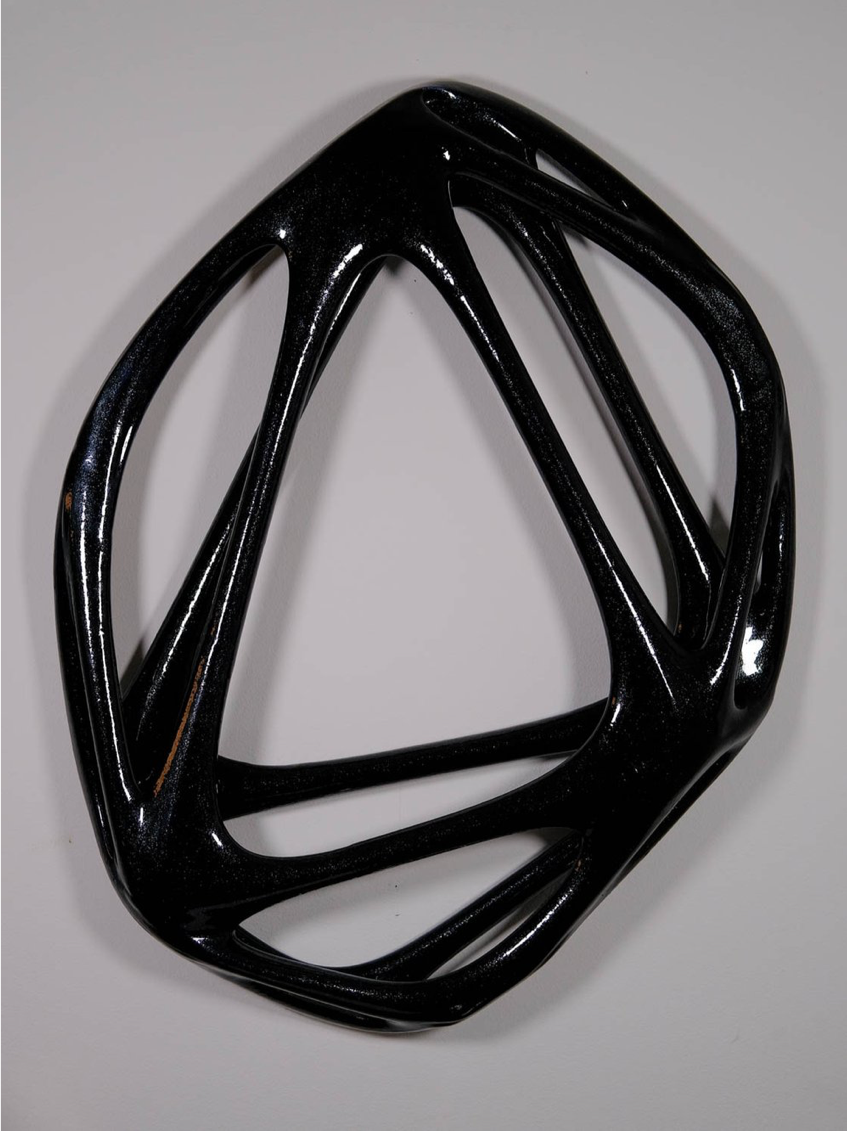 Absicca: Image description: statue of a black, circular, geometric artwork