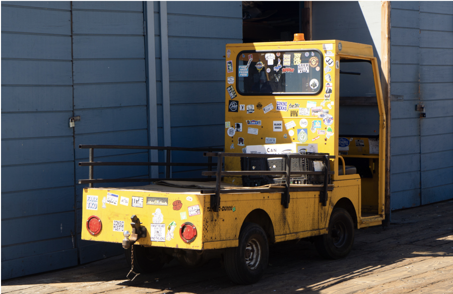 A photo of a work vehicle riddled with stickers 