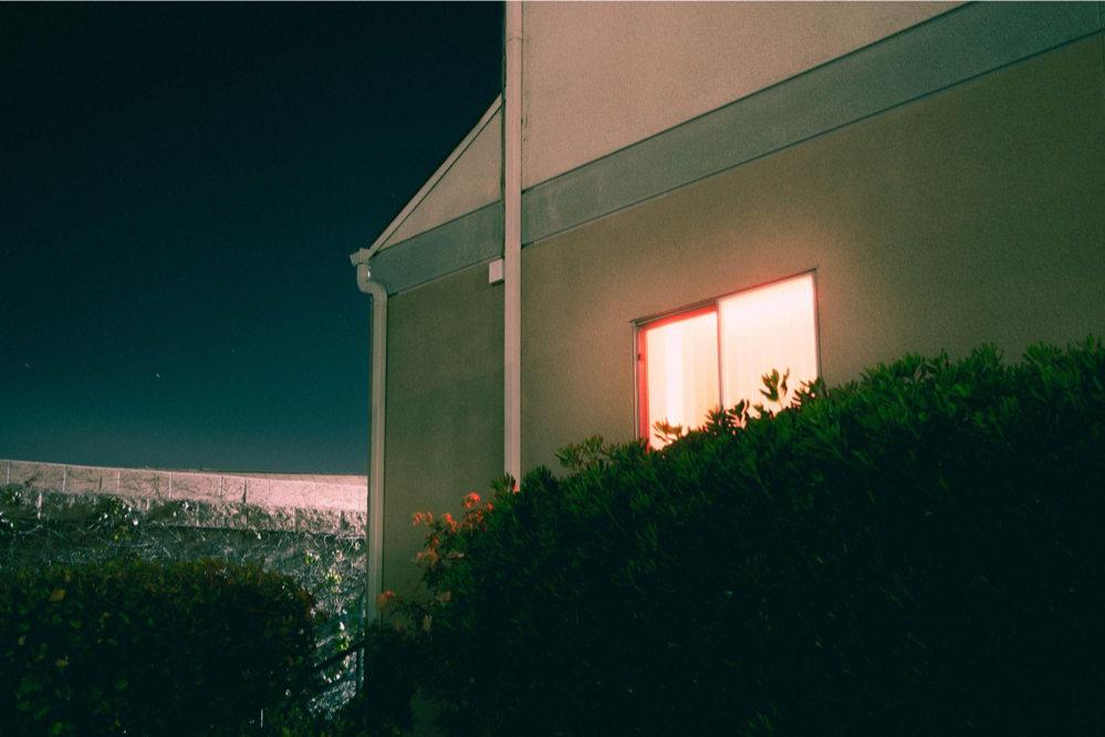 An image of a glowing window with the dark night sky behind it