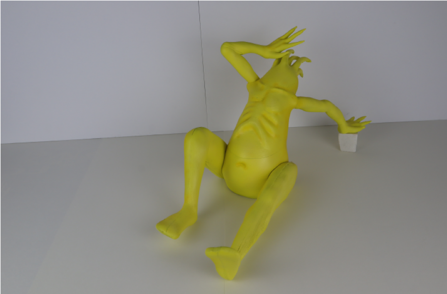 A photograph of a yellow creature like sculpture
