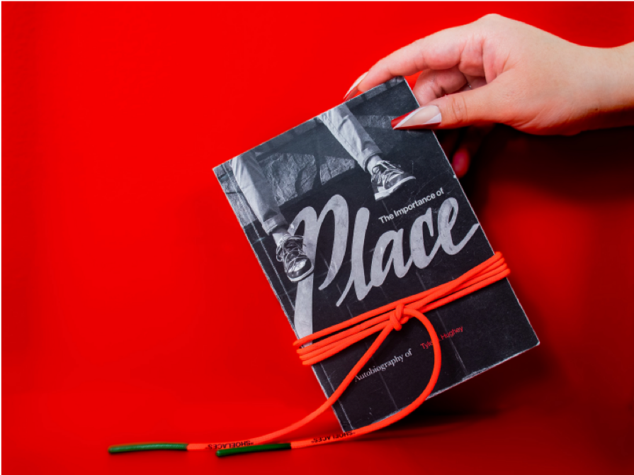 A picture of hand holding a book with a red background