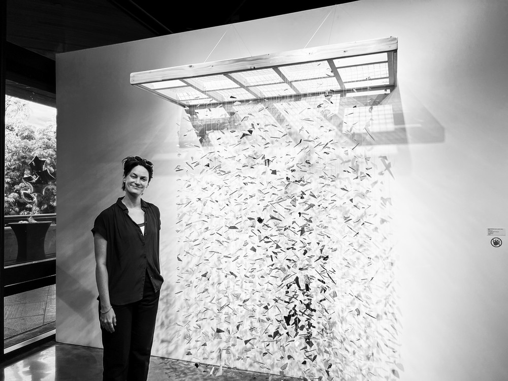 Isabel beavers next to one of her glass shard art work