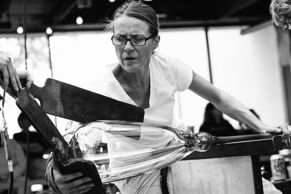 blakc and white photo of katherine blowing glass