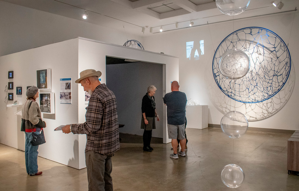 west gallery photo of people interacting with the documentary station