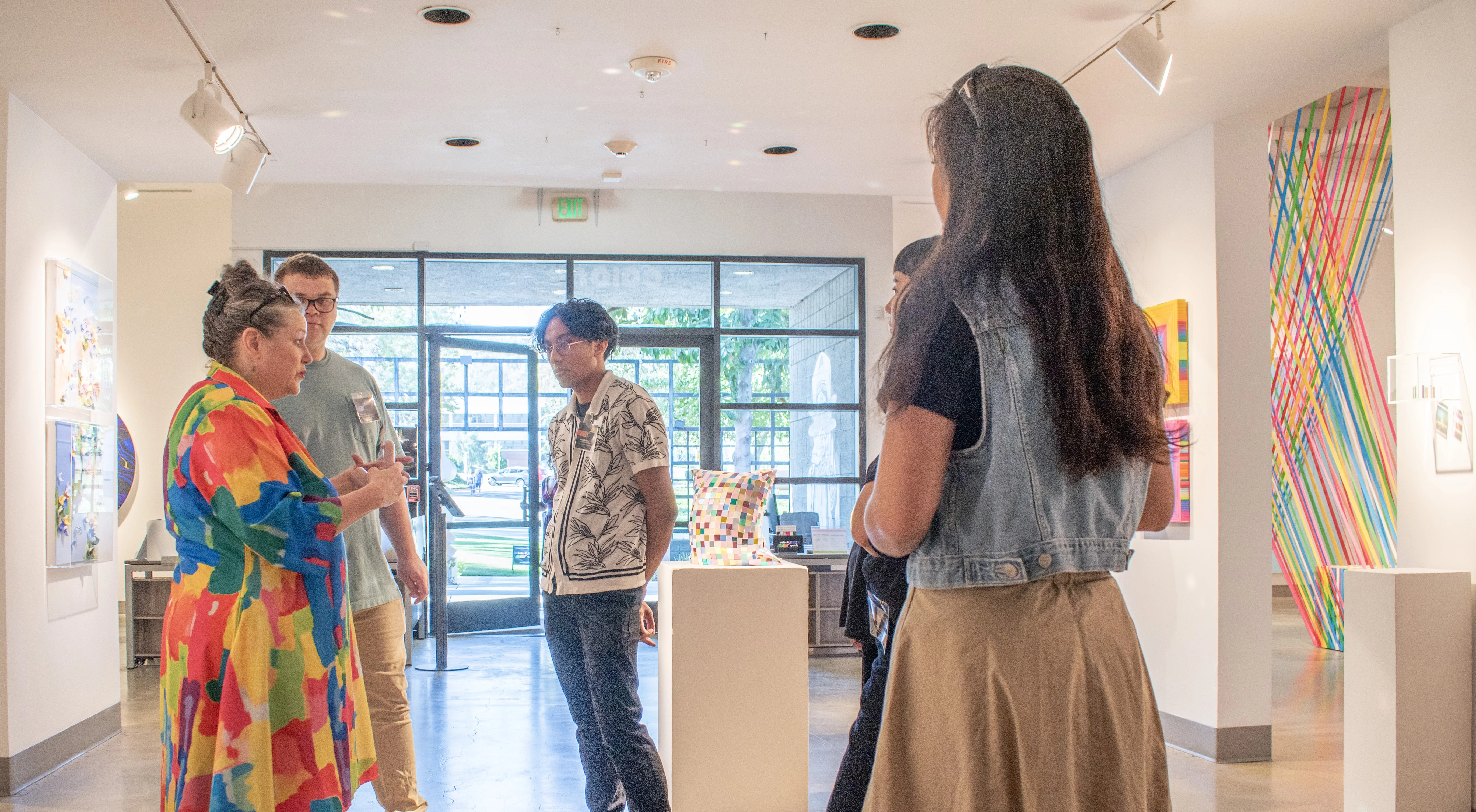 Gallery Curator Michele holds a staff meeting before the event begins.