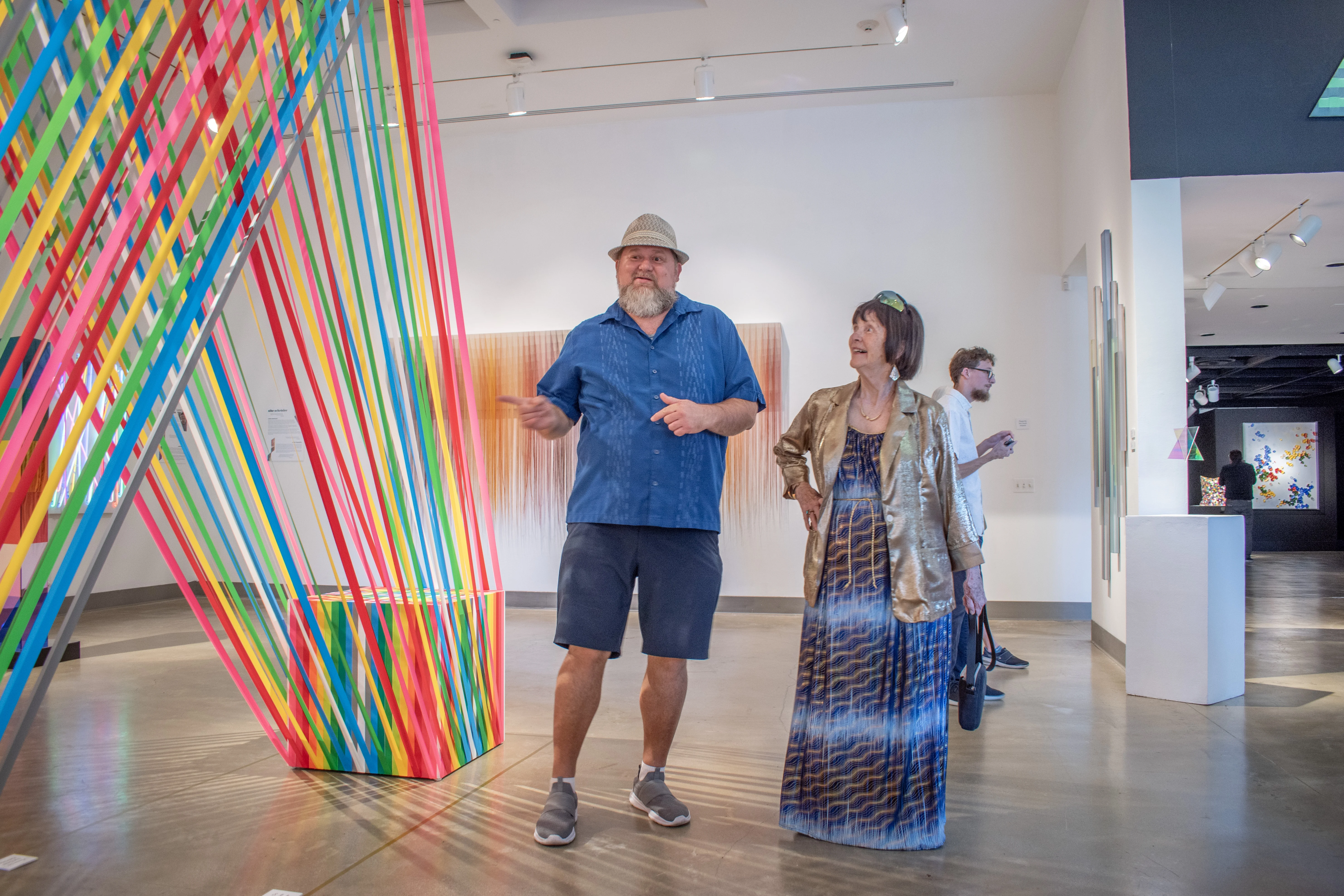 Guests looking at artwork within the east gallery.