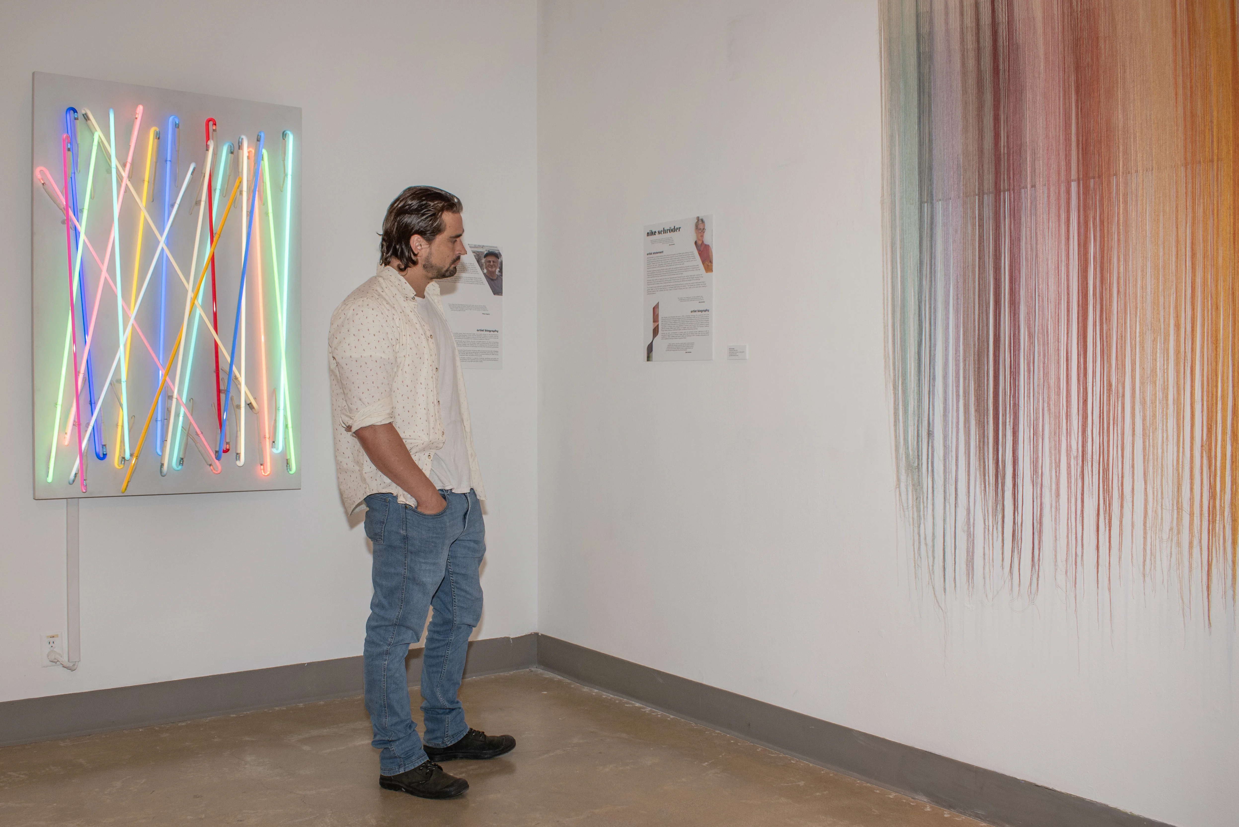 Visitor looking at one of Nike Schroeder's artworks.