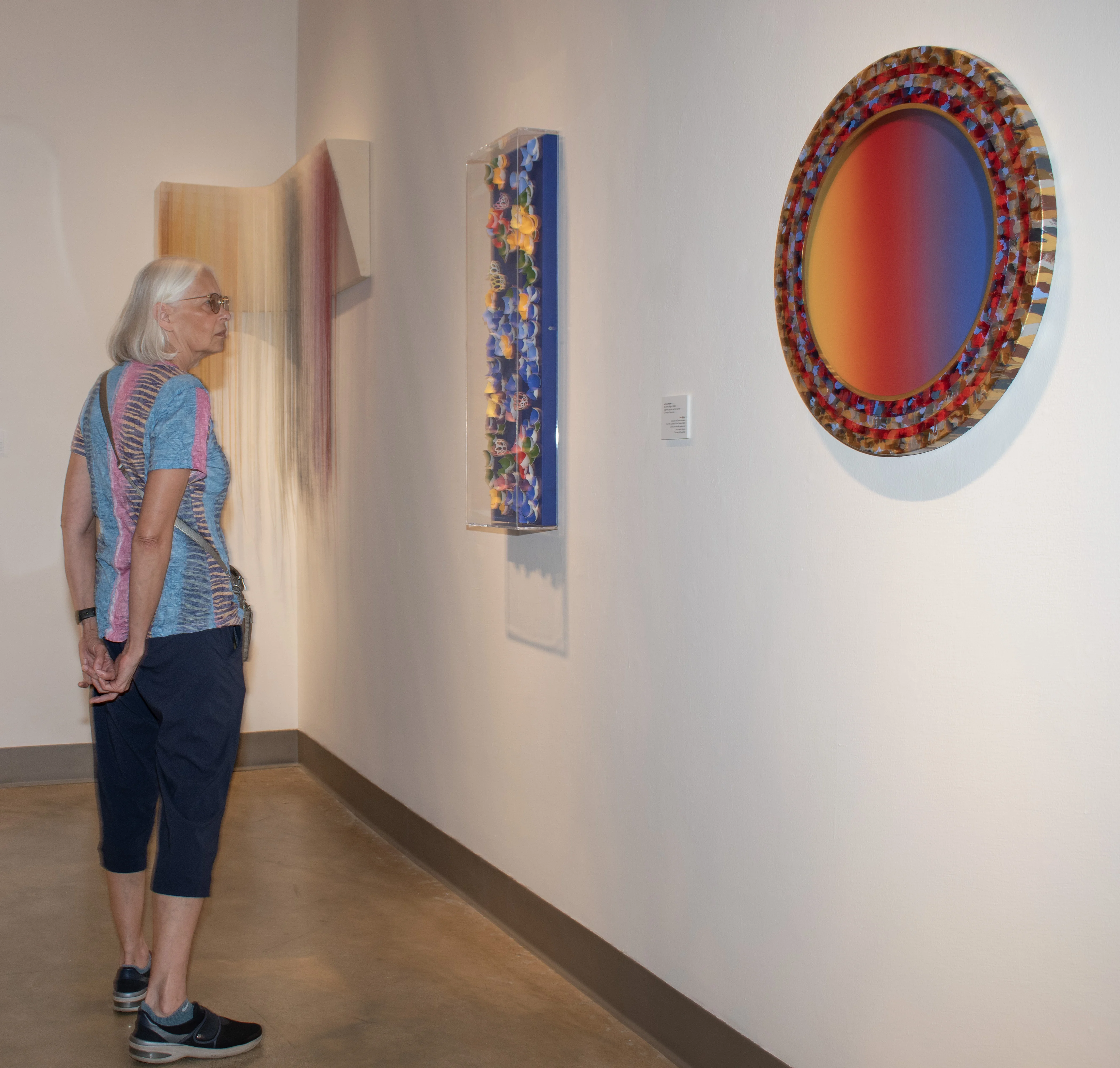 Visitor viewing artwork by Jack Reilly