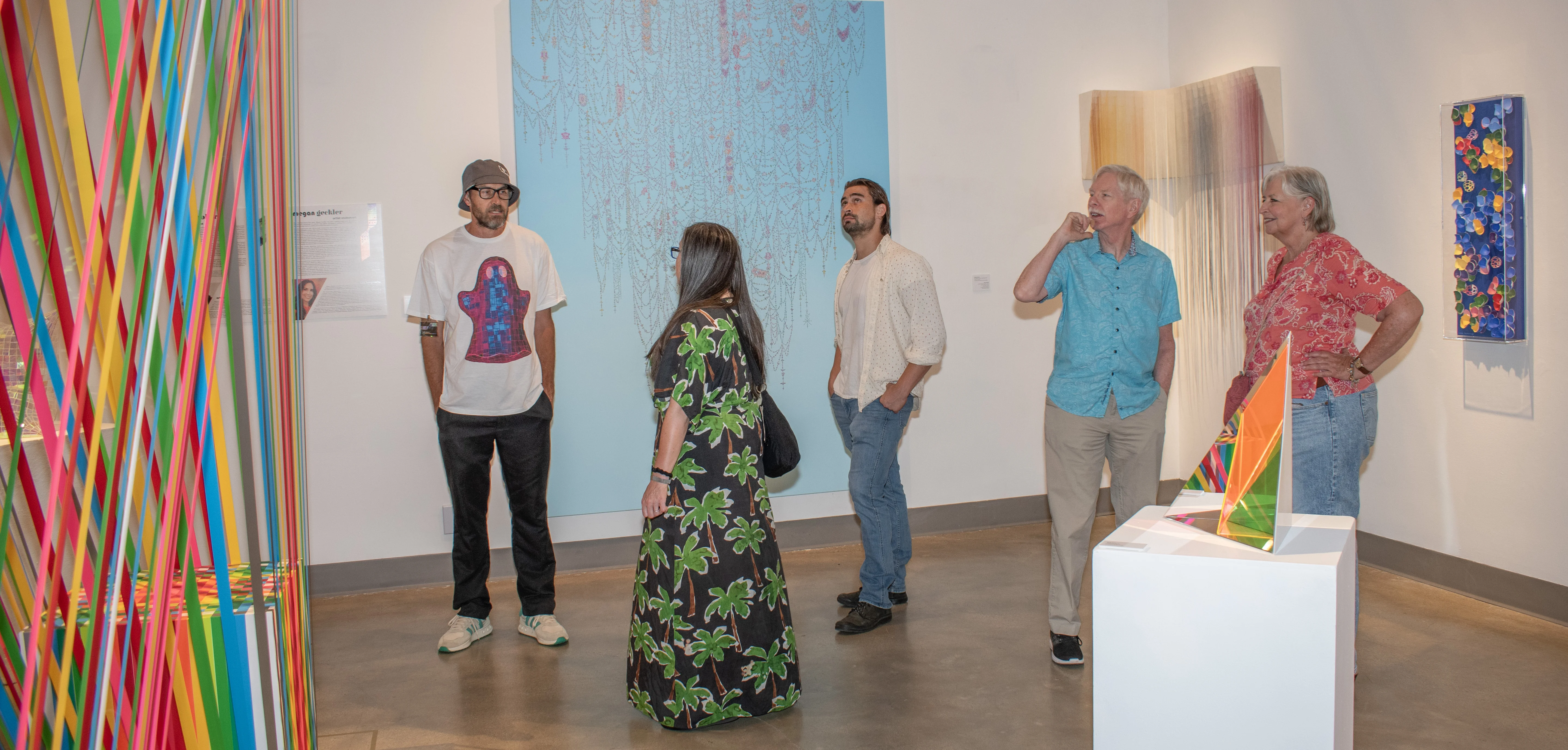 Guests observing artwork within the east gallery.