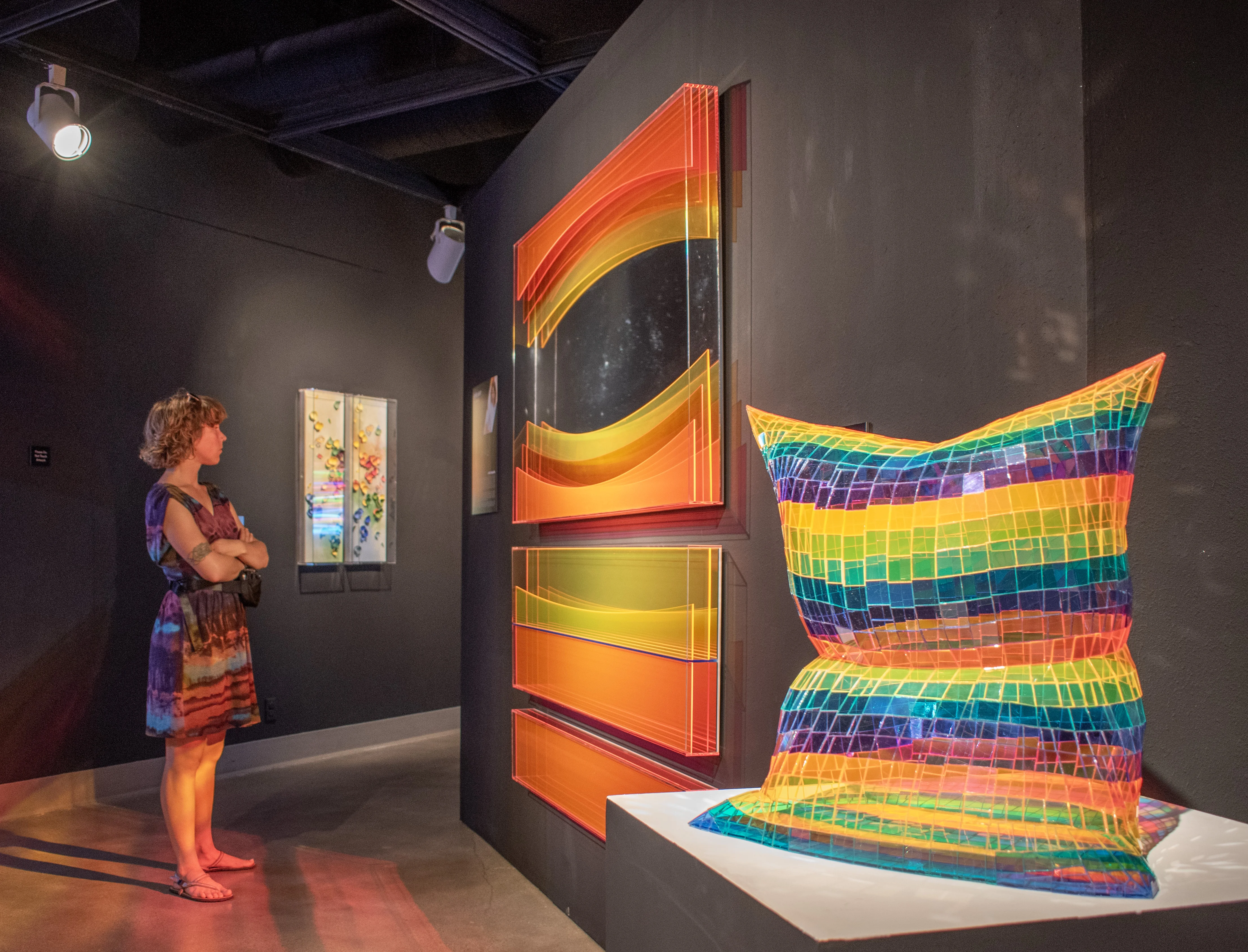 Guest observing artwork by Seda Saar within the back gallery.