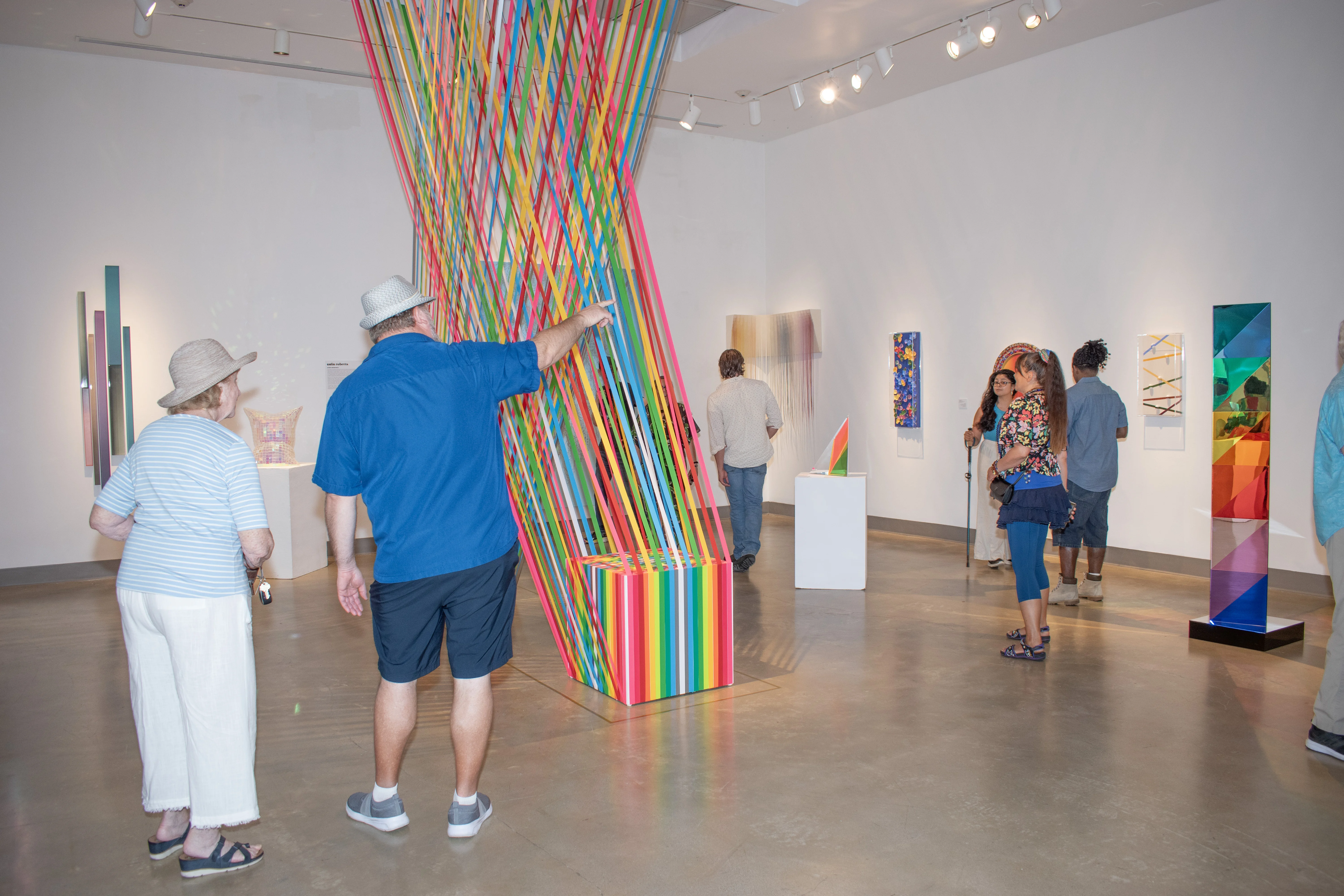 Guests observing artwork within the east gallery.