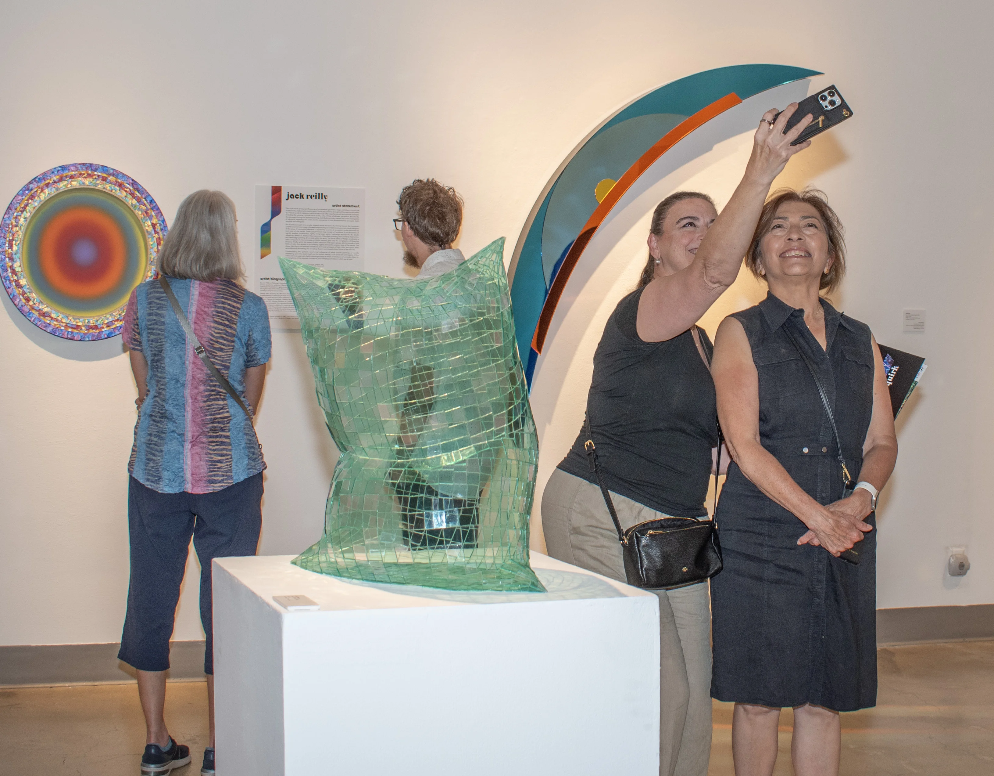 Guests taking photos and viewing artwork within the west gallery.