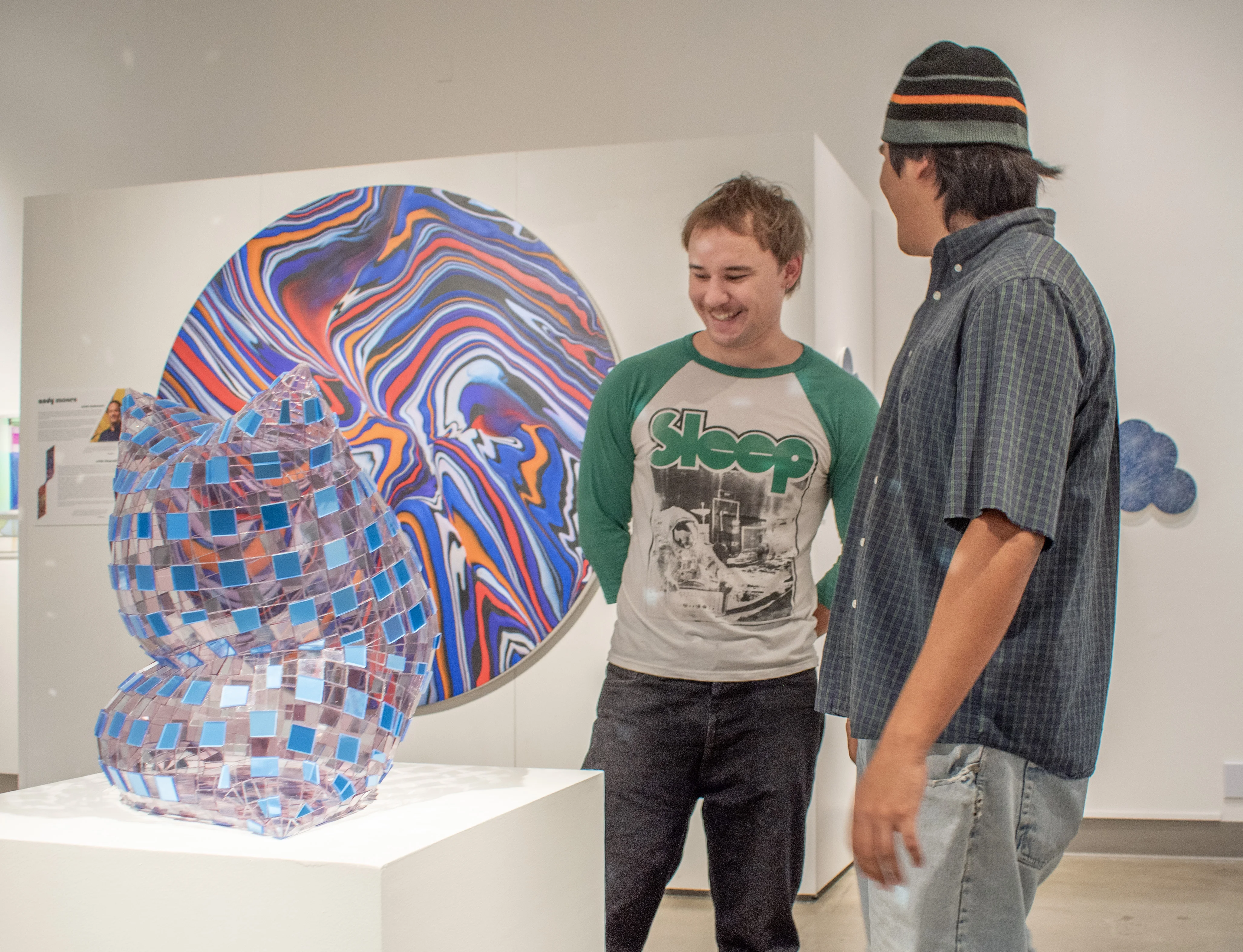 Guests observing artwork by Colin Roberts.