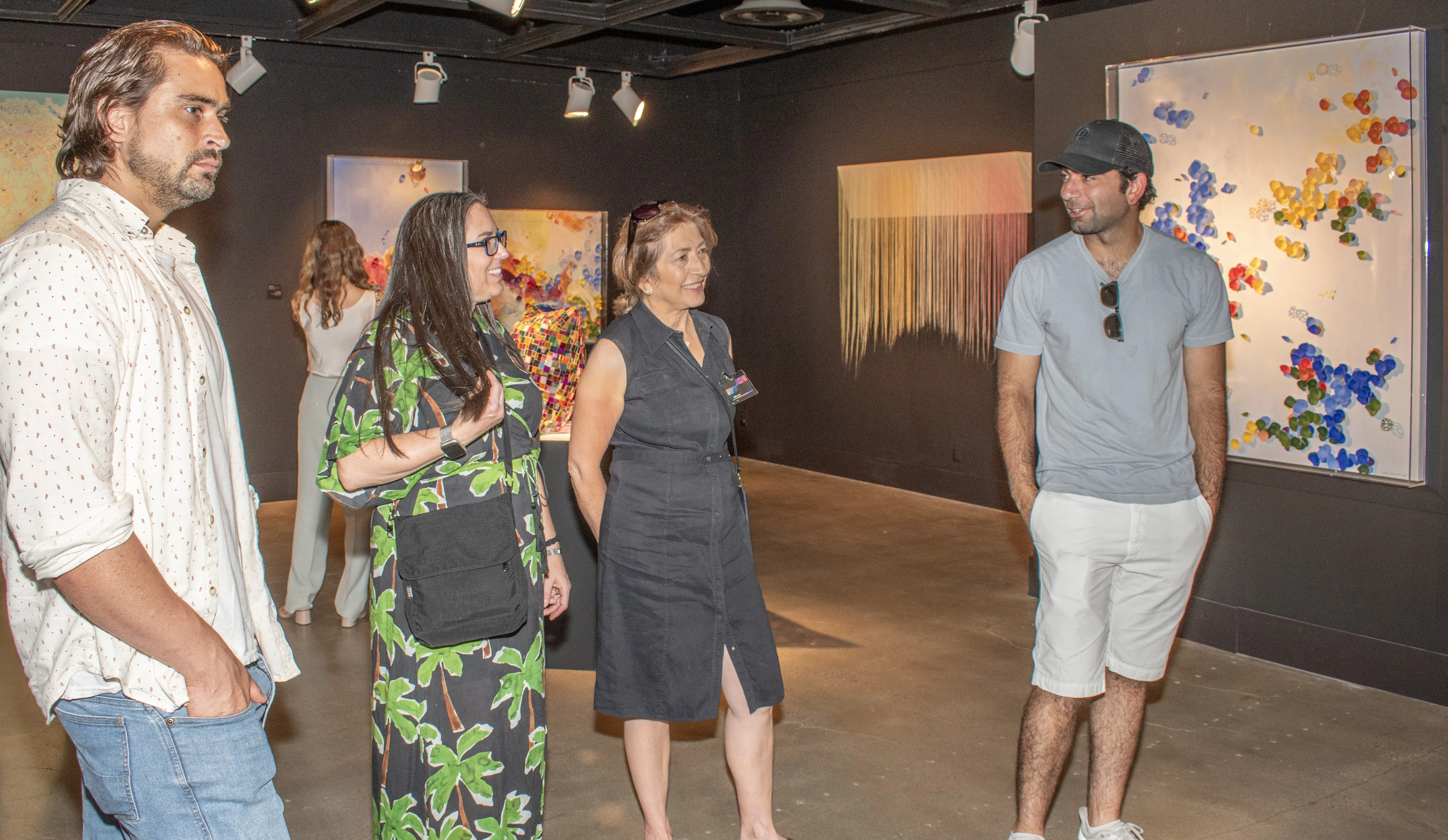 Artists Megan Geckler and Seda Saar observing the back gallery.