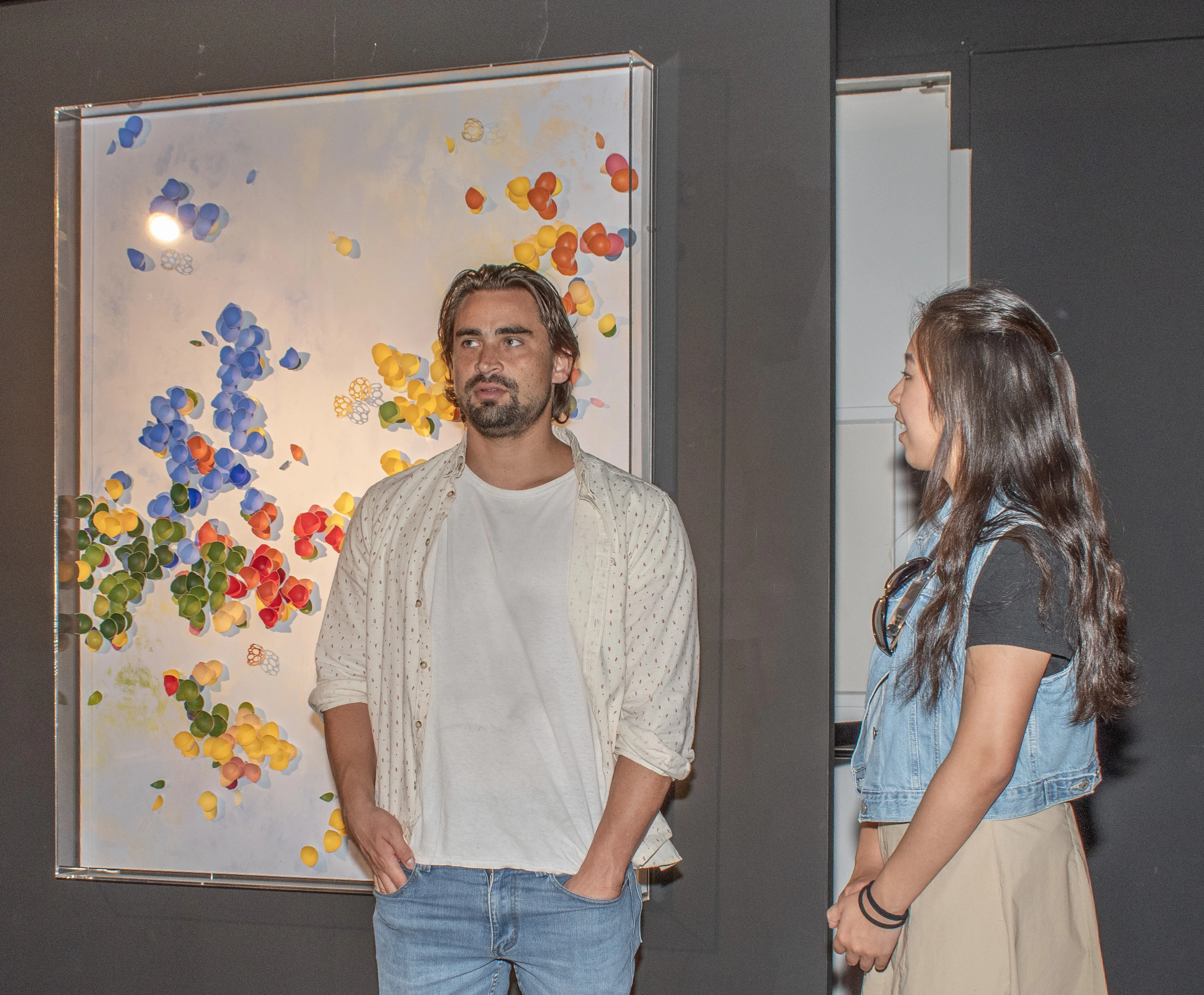 Guests observing artwork in the back gallery.