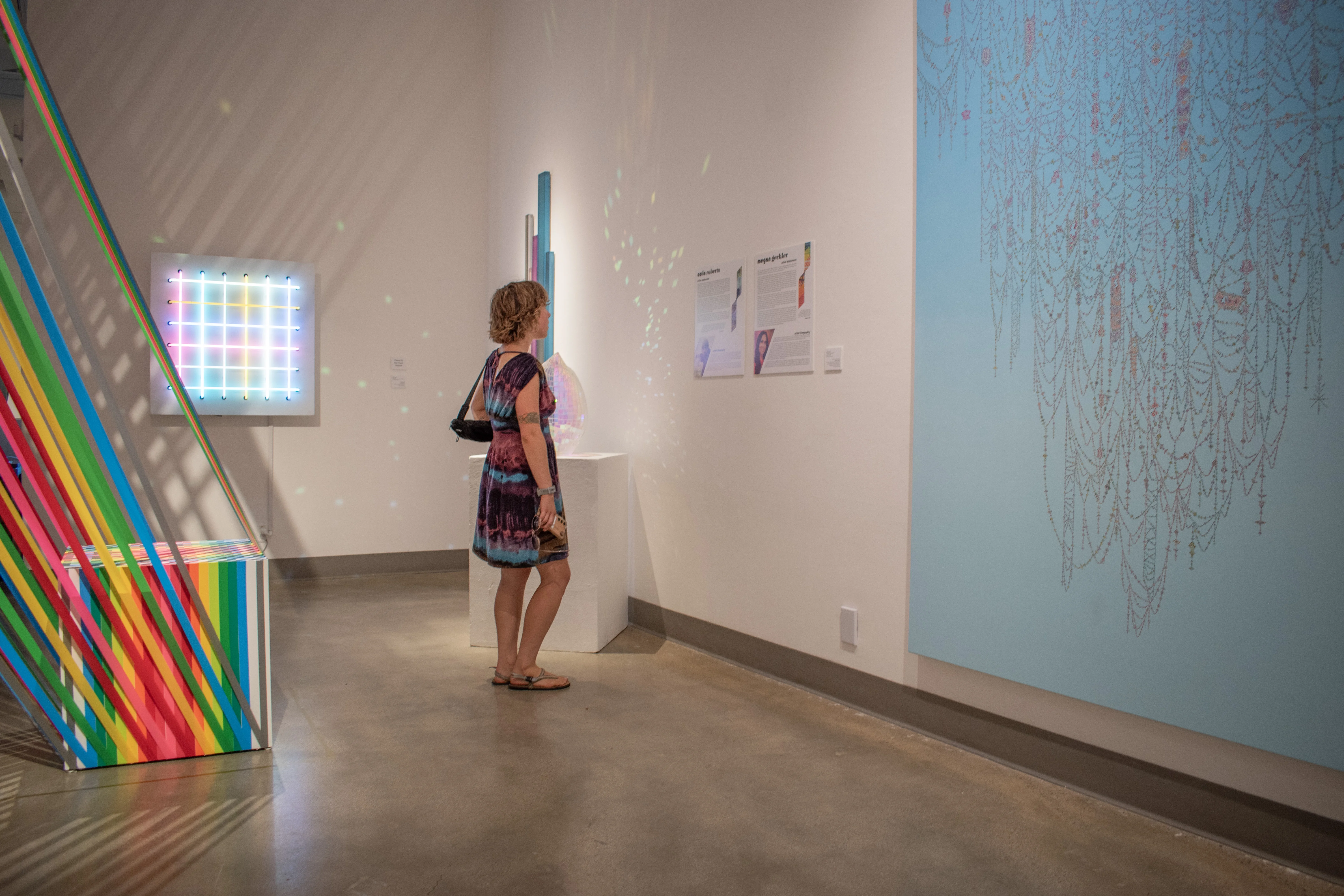 Guest observing artwork by Kelsey Brookes.