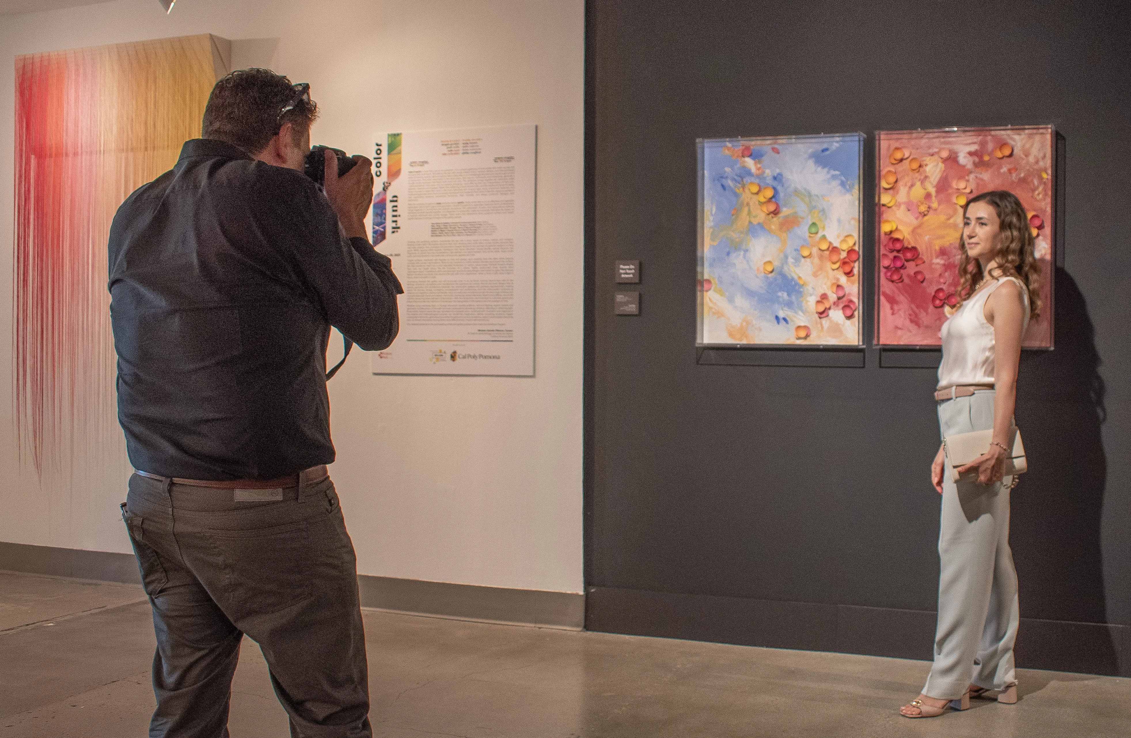 Artist Larisa Safaryan posing in front of her artwork.