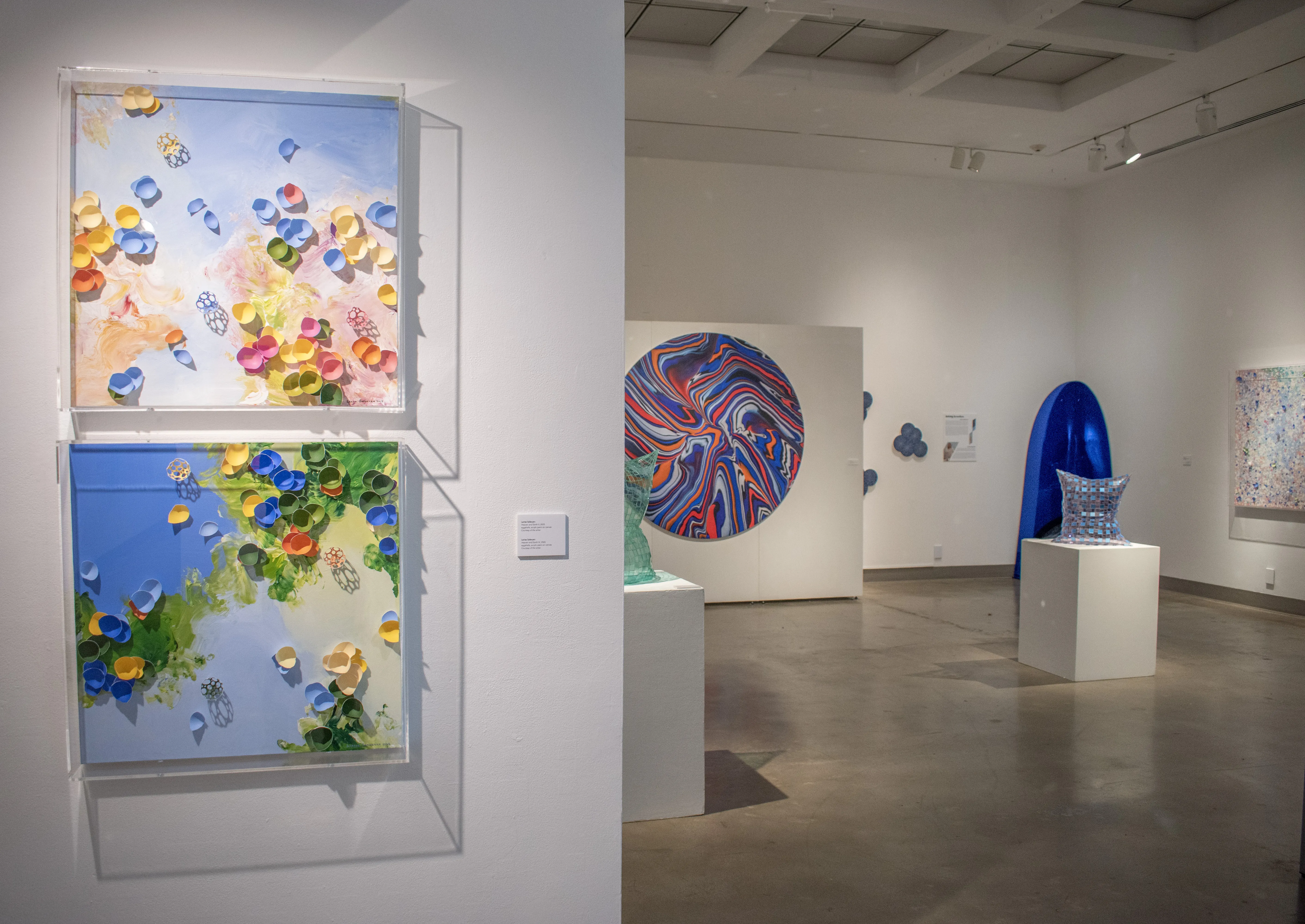 Installation view of gallery corridor peaking into the west gallery.