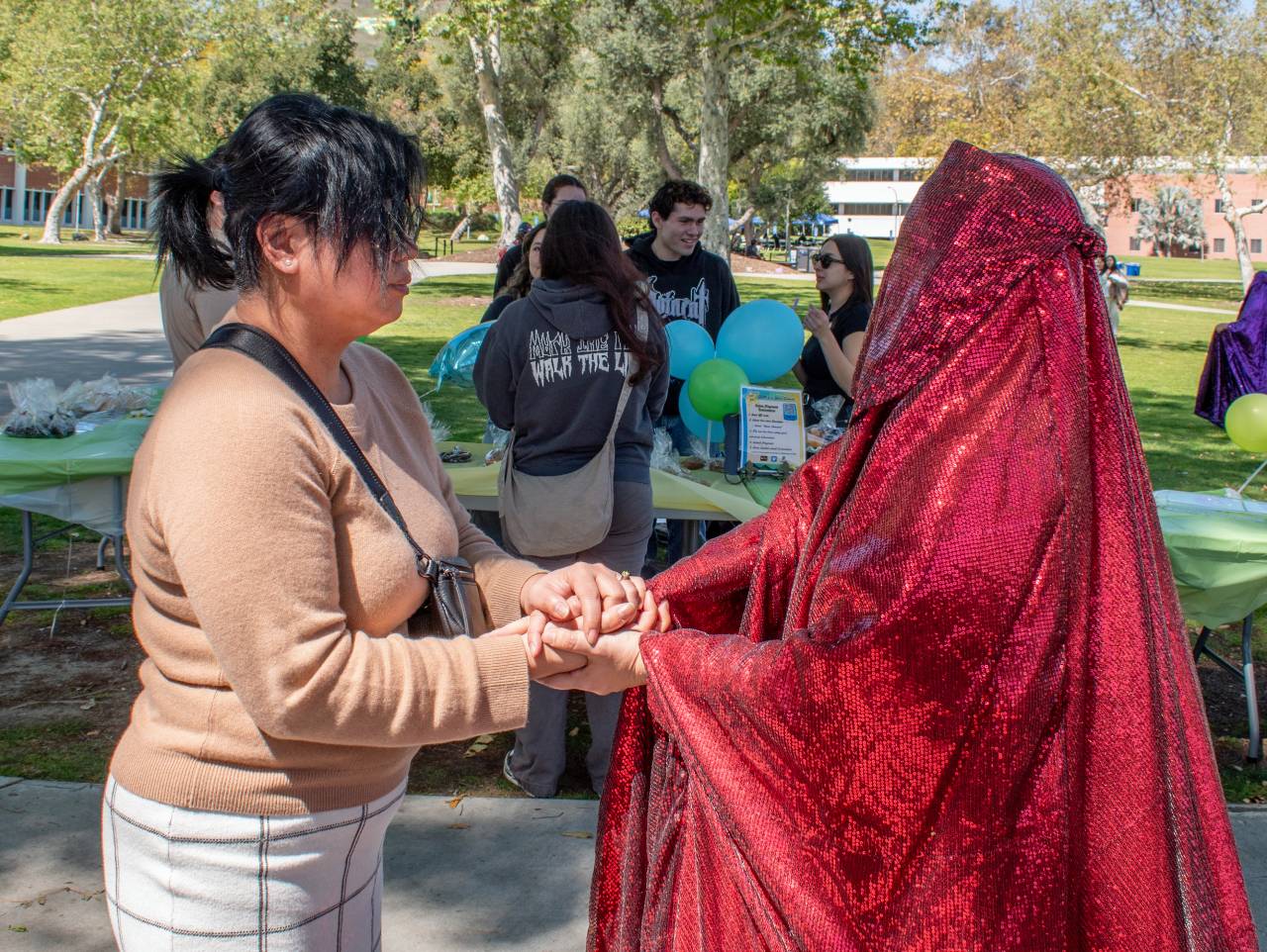 Red Chador interacting with a spectator.