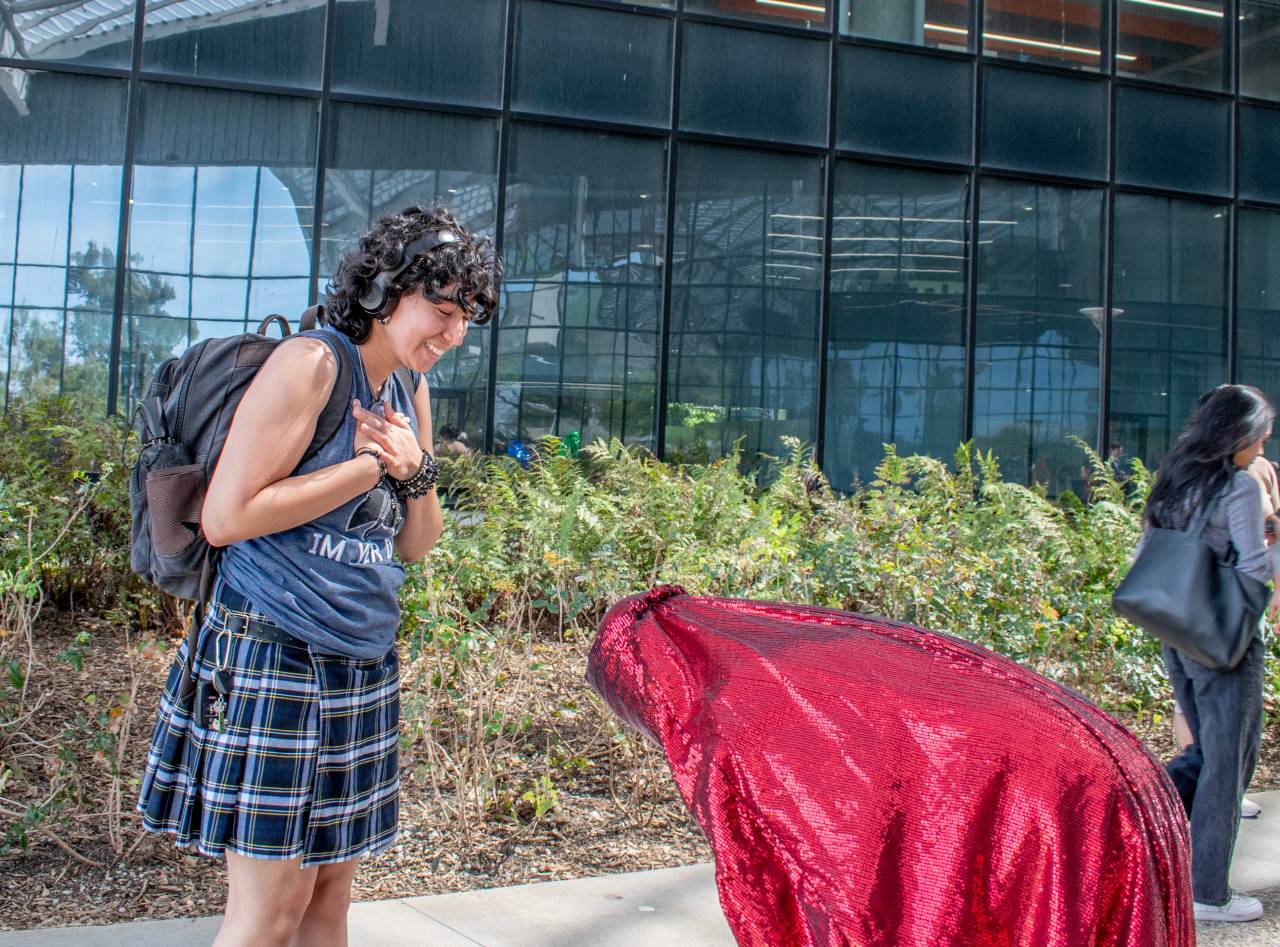 Red Chador interacting with a student.