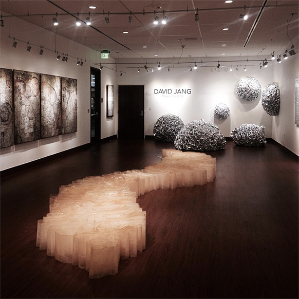 Image of gallery space with large abstract sculptures in the middle and back of gallery