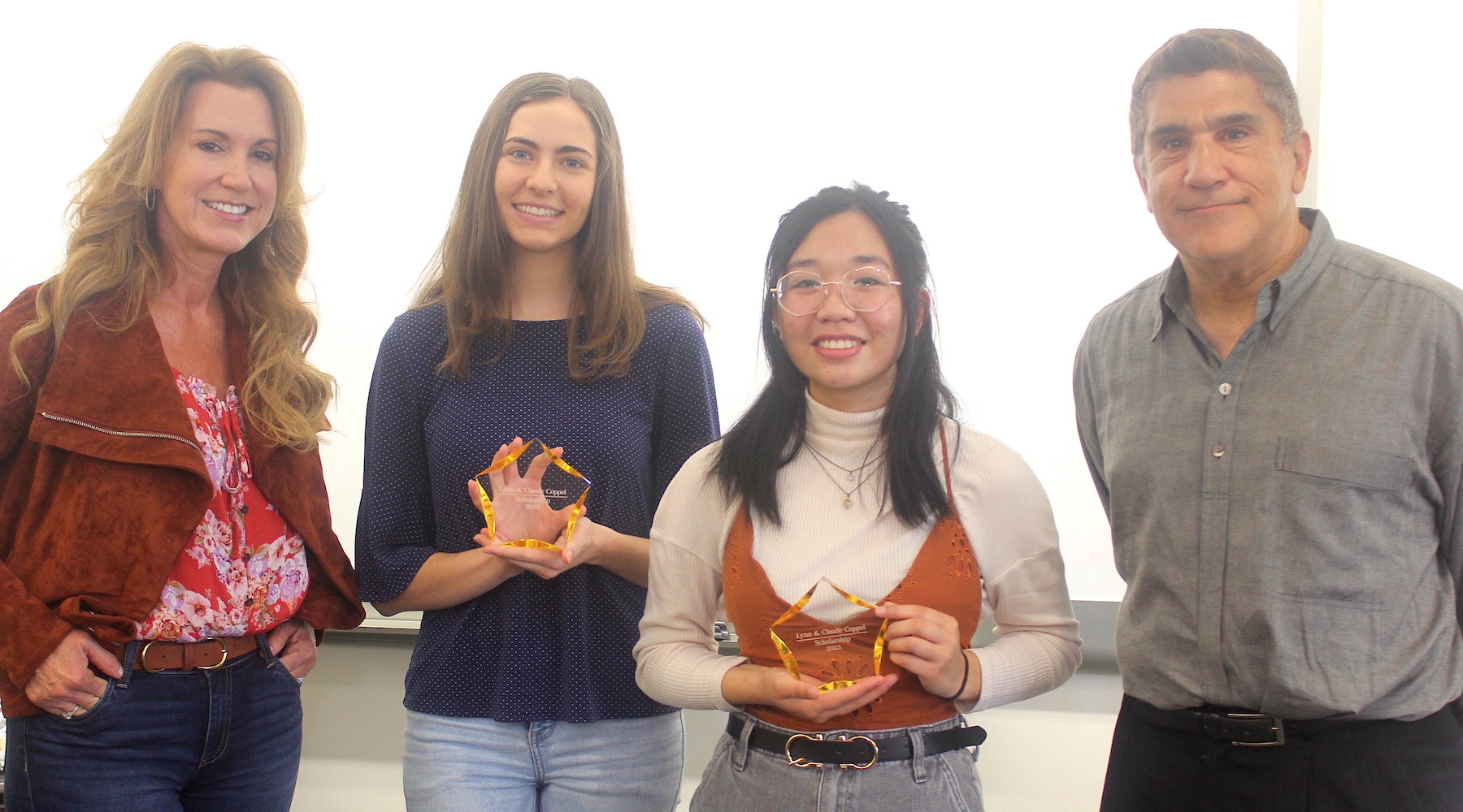 Recipients posing with awards and the Coppel family