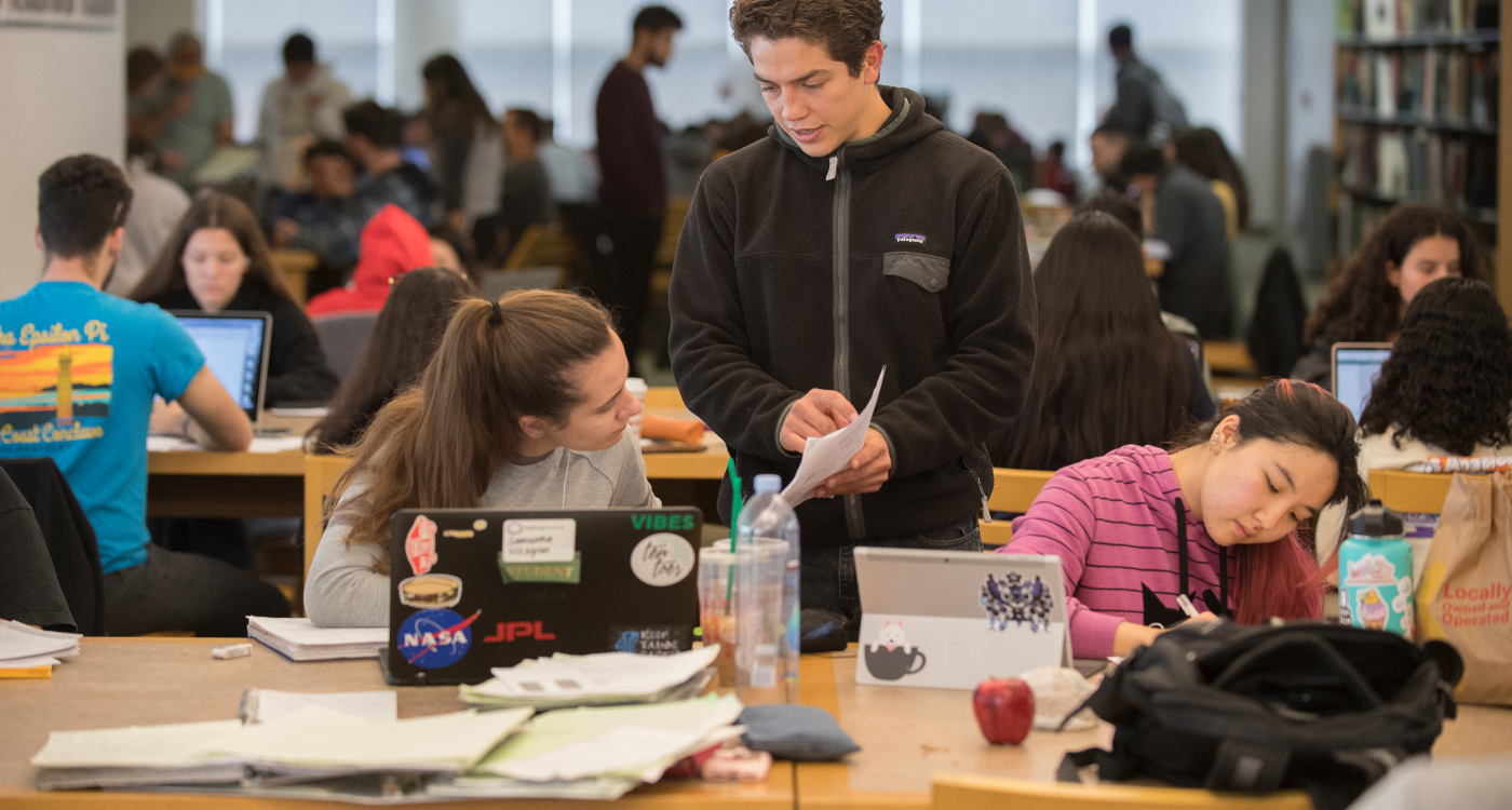 Three students study at the library