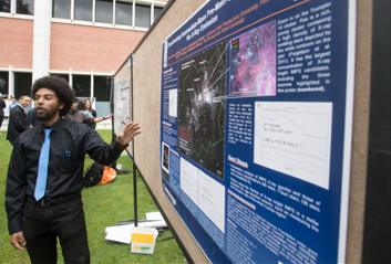 Student presenting his research on a poster