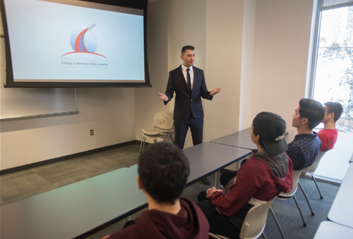 Students in room looking at a presentation