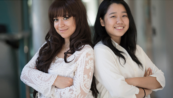 Two students posing back to back