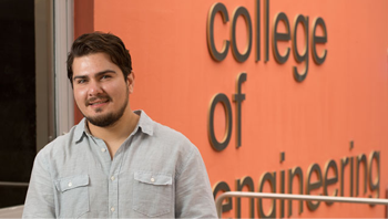 Student posing in front of the college of engineering