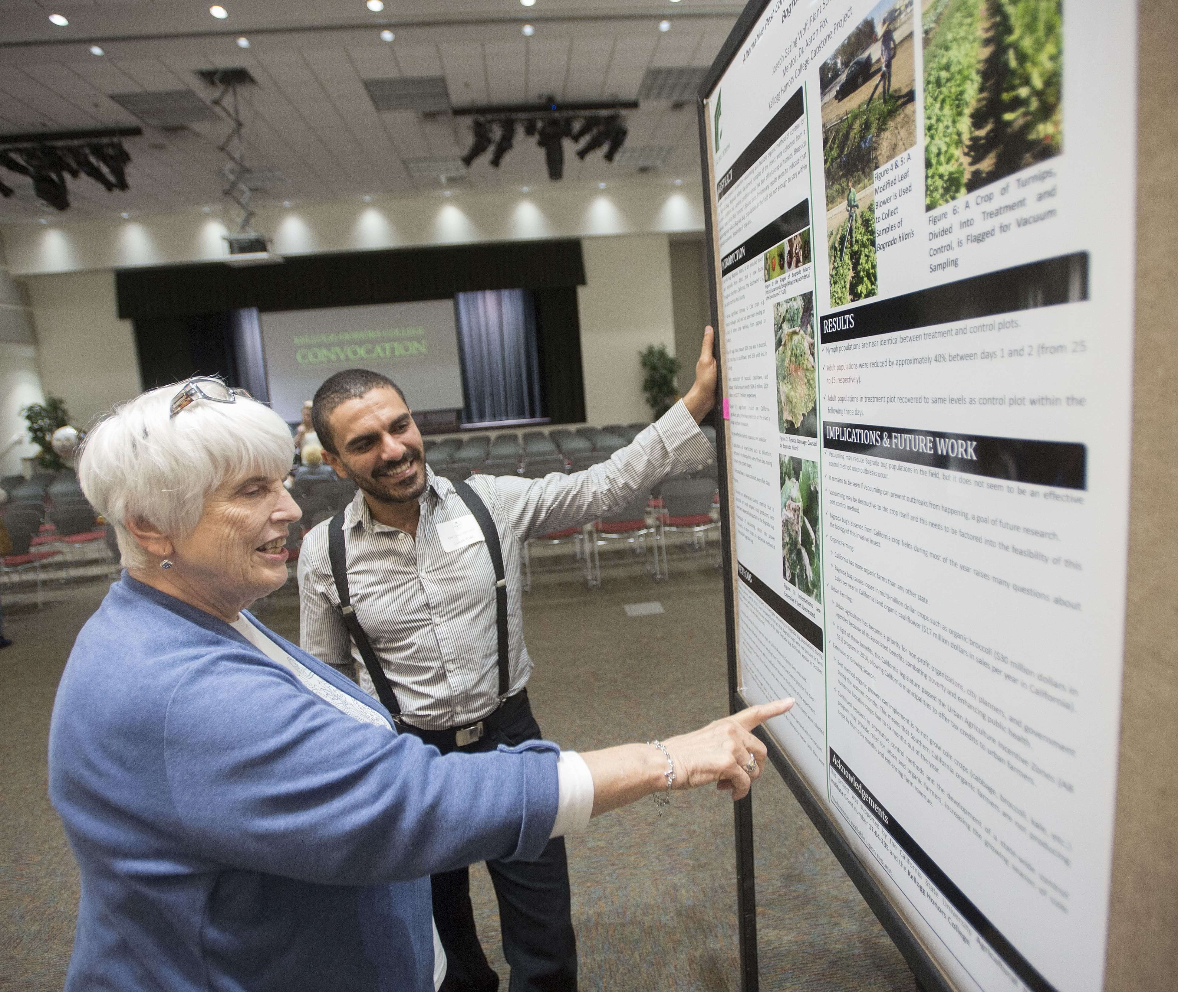 Student talking to person about his research at conference