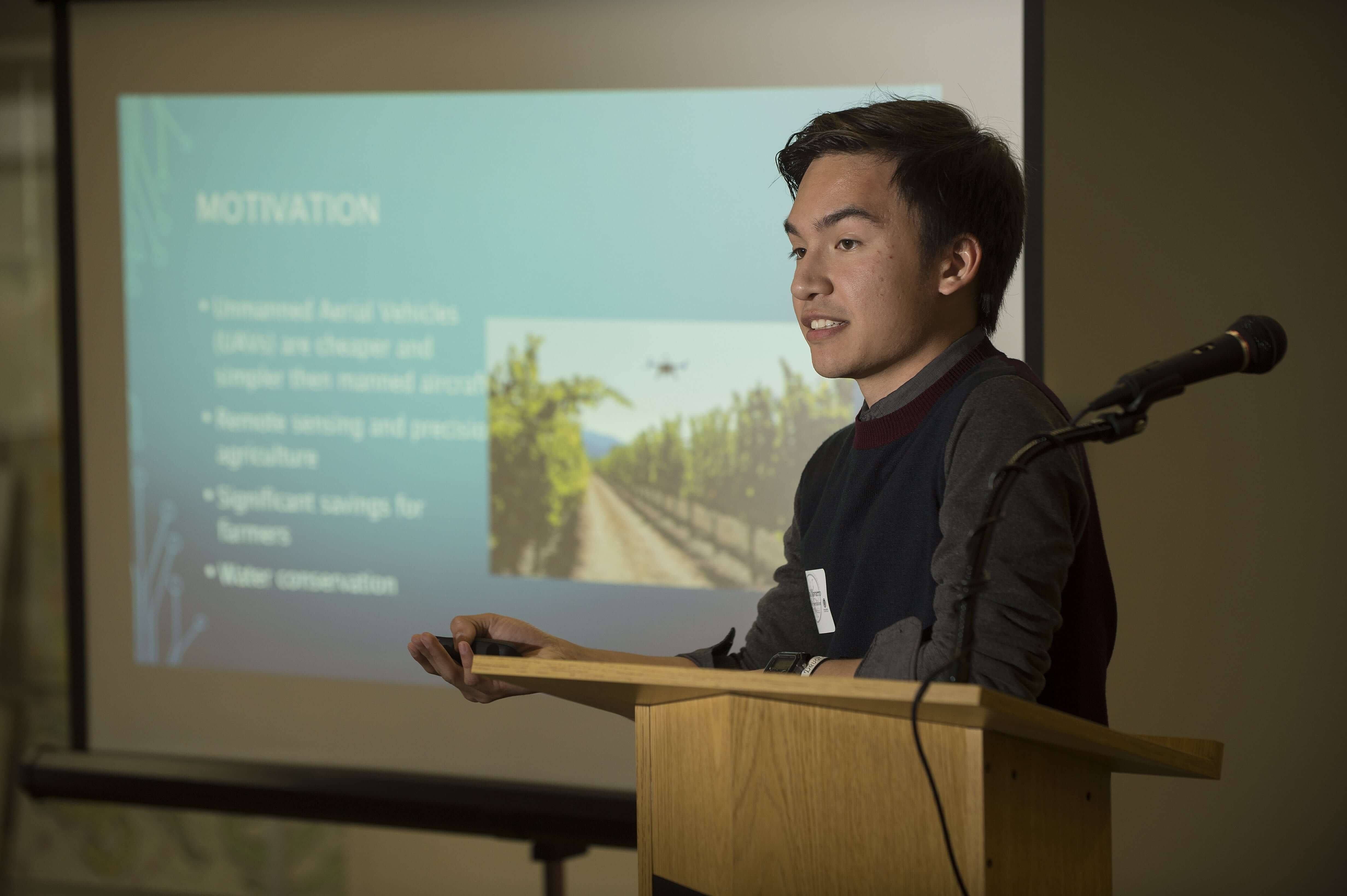 Student on podium at research conference