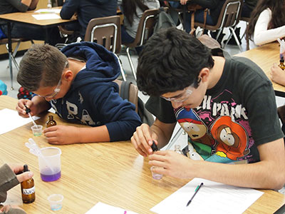 Science students conducting chemistry experiments