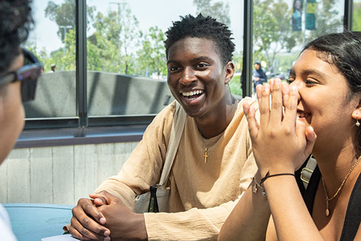 Cal Poly Pomona students chatting outside the Student Services Building