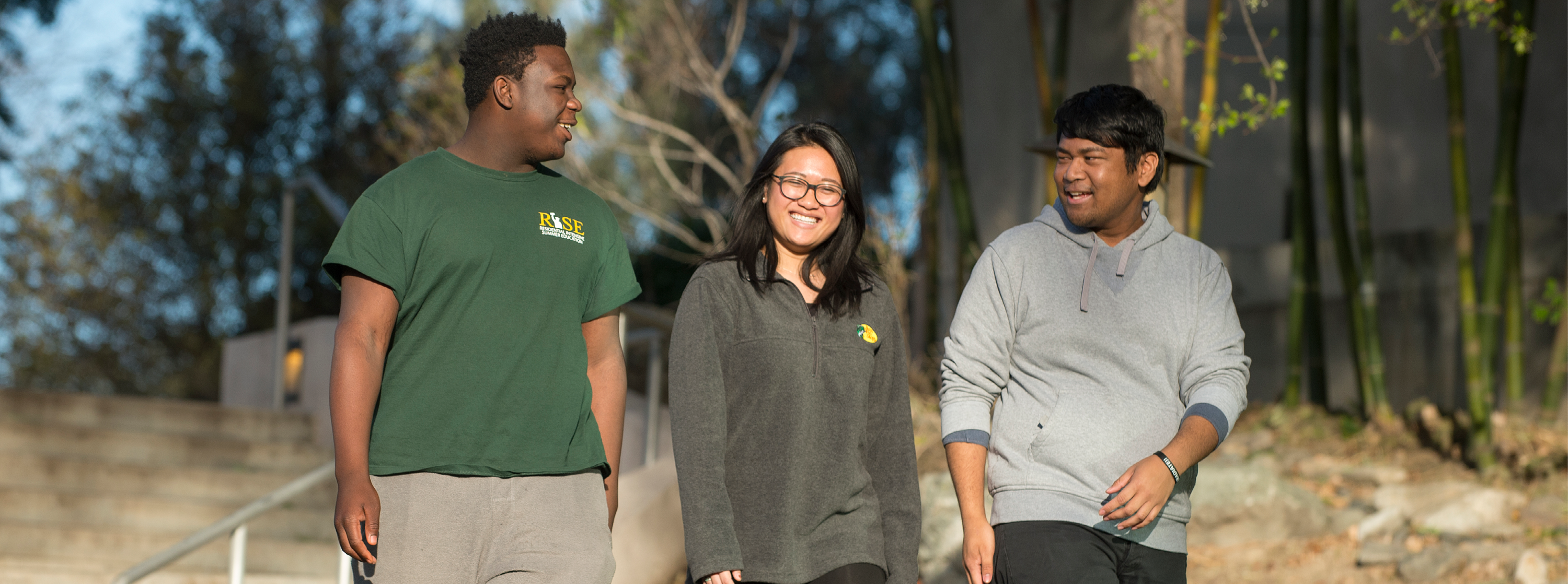 Three students walk in the Japanese Garden